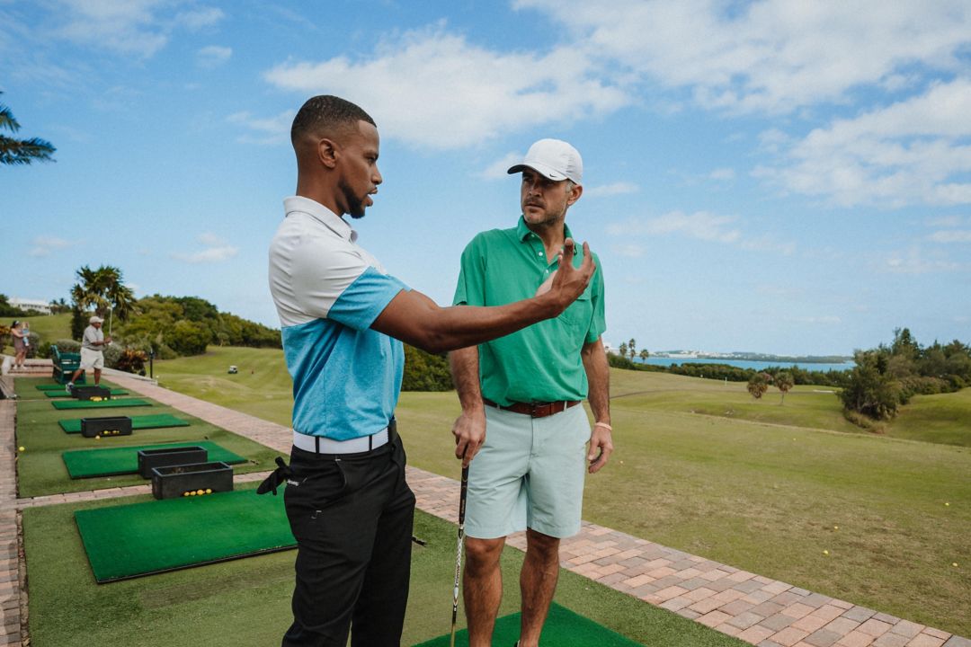 Golf instructor teaching golf guest